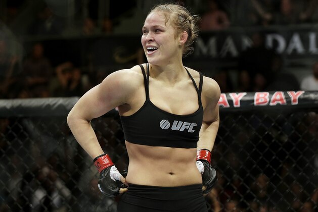 FILE - In this Feb. 22, 2014, file photo, Ronda Rousey looks around after defeating Sara McMann in a UFC 170 mixed martial arts women's bantamweight title bout in Las Vegas. Gina Carano was scheduled to meet with UFC President Dana White on Wednesday April 9, to discuss a return to mixed martial arts for a potential bout with bantamweight champion Rousey. (AP Photo/Isaac Brekken, File)