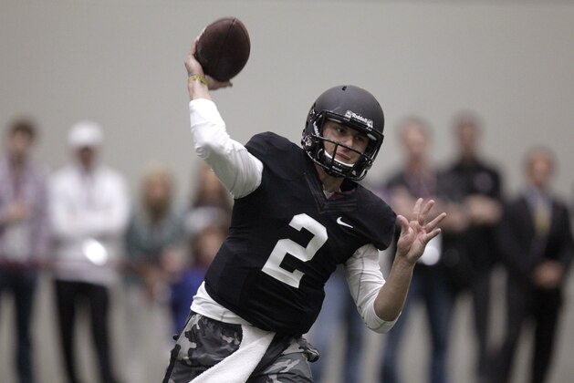 Texas A&M quarterback Johnny Manziel passes the ball during a drill at pro day for NFL football representatives in College Station, Texas, Thursday, March 27, 2014. (AP Photo/Patric Schneider)
