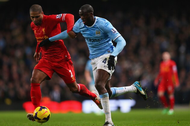 MANCHESTER, ENGLAND - DECEMBER 26:  Yaya Toure of Manchester City is closed down by Glen Johnson of Liverpool during the Barclays Premier League match between Manchester City and Liverpool at Etihad Stadium on December 26, 2013 in Manchester, England.  (Photo by Alex Livesey/Getty Images)