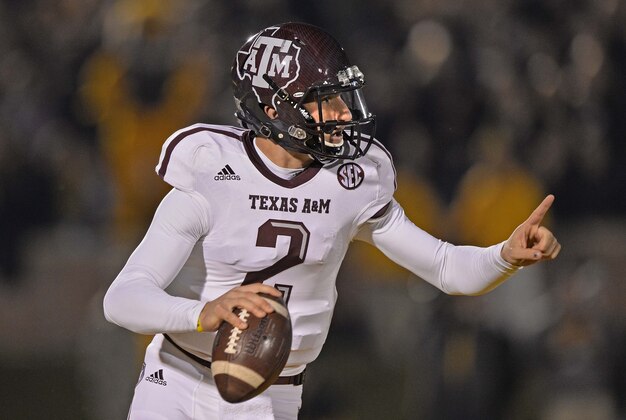 Nov 30, 2013; Columbia, MO, USA; Texas A&M Aggies quarterback Johnny Manziel (2) rolls out against the Missouri Tigers during the first half at Faurot Field. Mandatory Credit: Peter G. Aiken-USA TODAY Sports