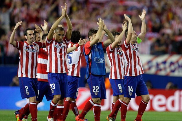 Atletico players celebrate at the end of the Champions League quarterfinal second leg soccer match between Atletico Madrid and FC Barcelona in the Vicente Calderon stadium in Madrid, Spain, Wednesday, April 9, 2014. Atletico defeated Barcelona 1-0. (AP Photo/Paul White)