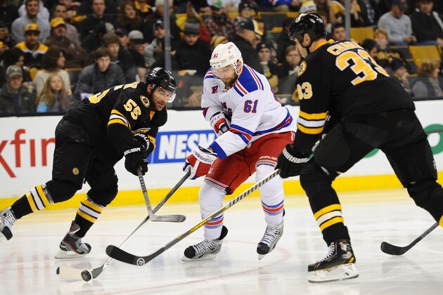 BOSTON, MA - NOVEMBER 29: Rick Nash #61 of the New York Rangers skates with the puck against Johnny Boychuk #55 and Zdeno Chara #33 the Boston Bruins at the TD Garden on November 29, 2013 in Boston, Massachusetts.  (Photo by Brian Babineau/NHLI via Getty Images)