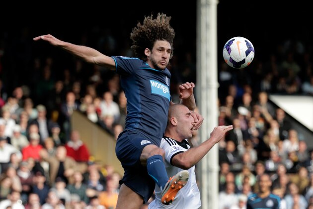 Fulham's Pajtim Kasami, right, competes for the ball with Newcastle United's Fabricio Coloccini during the English Premier League soccer match between Fulham and Newcastle United at Craven Cottage stadium in London, Saturday, March 15, 2014.  (AP Photo/Matt Dunham)