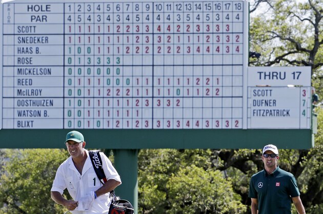 Adam Scott, of Australia, and his caddie Steve Williams walk up the 18th fairway during the first round of the Masters golf tournament Thursday, April 10, 2014, in Augusta, Ga. (AP Photo/David J. Phillip)