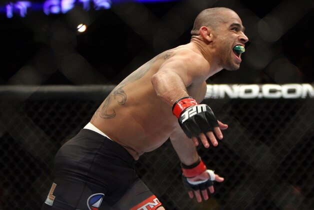 Renan Barao celebrates after beating Urijah Faber of Sacramento, CA during the first round of the Ultimate Fighting Bantamweight Championship Mixed Martial Arts bout in Newark, N.J. on Saturday, Feb. 1, 2014. Barao won after referee Herb Dean called the fight in the first round. (AP Photo/Tim Larsen)