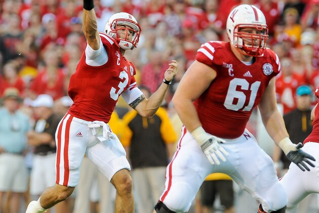 LINCOLN, NE - AUGUST 31: Quarterback Taylor Martinez #3 of the Nebraska Cornhuskers throws over teammate offensive linesman Spencer Long #61 and the Wyoming Cowboys during their game at Memorial Stadium on August 31, 2013 in Lincoln, Nebraska.  (Photo by Eric Francis/Getty Images)
