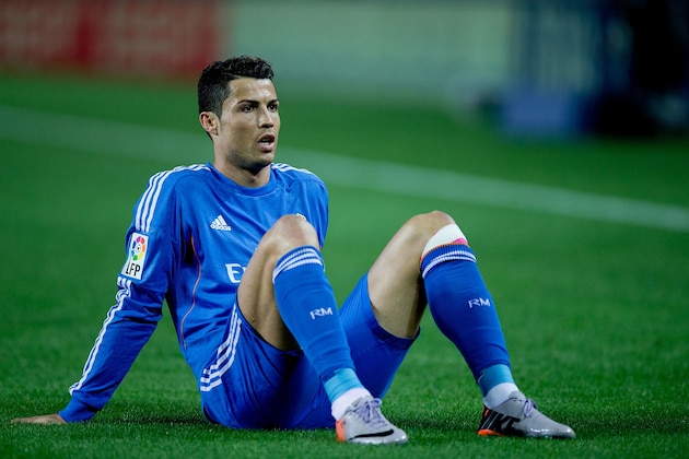 SEVILLE, SPAIN - MARCH 26:  Cristiano Ronaldo of Real Madrid CF lies on the ground after being tackled during the La Liga match between Sevilla FC and Real Madrid CF at Estadio Ramon Sanchez Pizjuan on March 26, 2014 in Seville, Spain.  (Photo by Gonzalo Arroyo Moreno/Getty Images)