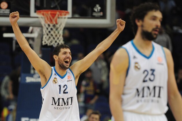 Real Madrid's Nikola Mirotic, right, dribbles past Barcelona Regal's Erazem Lorbek, left, during a Euroleague Final-Four semi-final basketball game at the O2 Arena, in London, Friday, May 10, 2013. (AP Photo/Lefteris Pitarakis)