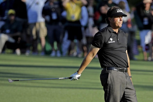 Phil Mickelson reacts after putting his third shot into the water on the 15th hole during the first round of the Masters golf tournament Thursday, April 10, 2014, in Augusta, Ga. (AP Photo/David J. Phillip)