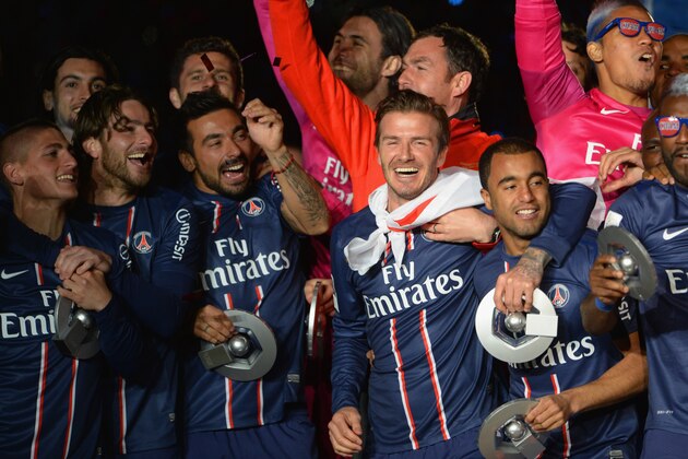 PARIS, FRANCE - MAY 18: David Beckham celebrates with PSG team mates after the Ligue 1 match between Paris Saint-Germain FC and Stade Brestois 29 at Parc des Princes on May 18, 2013 in Paris, France.  (Photo by Michael Regan/Getty Images)