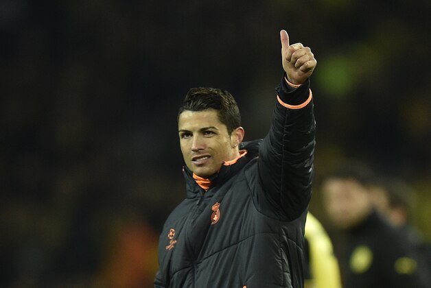 Real's Cristiano Ronaldo waves to his supporters at the end of the the Champions League quarterfinal second leg soccer match between Borussia Dortmund and Real Madrid in the Signal Iduna stadium in Dortmund, Germany, Tuesday, April 8, 2014. (AP Photo/Martin Meissner)