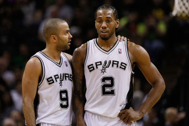 Mar 26, 2014; San Antonio, TX, USA; San Antonio Spurs guard Tony Parker (9) talks with Kawhi Leonard (2) during the second half against the Denver Nuggets at AT&T Center. Mandatory Credit: Soobum Im-USA TODAY Sports