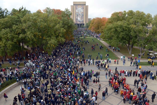 Oct 19, 2013; South Bend, IN, USA; Notre Dame Fighting Irish coach Brian Kelly leads players into Notre Dame Stadium with the Hesburgh Library Word of Life Mural aka Touchdown Jesus before the game against the Southern California Trojans. Mandatory Credit: Kirby Lee-USA TODAY Sports