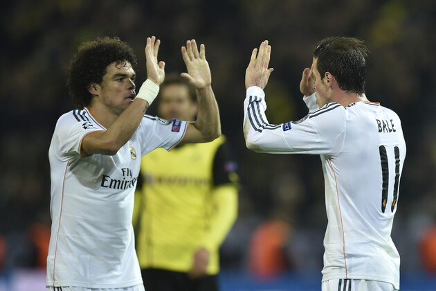 Real's Pepe celebrates with Gareth Bale, right, at the end of the the Champions League quarterfinal second leg soccer match between Borussia Dortmund and Real Madrid in the Signal Iduna stadium in Dortmund, Germany, Tuesday, April 8, 2014. (AP Photo/Martin Meissner)
