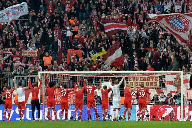 Bayern's players celebrate with supporters after the Champions League quarterfinal second leg soccer match between Bayern Munich and Manchester United in the Allianz Arena in Munich, Germany, Wednesday, April 9, 2014. Munich defeated Manchester by 3-1. (AP Photo/Kerstin Joensson)