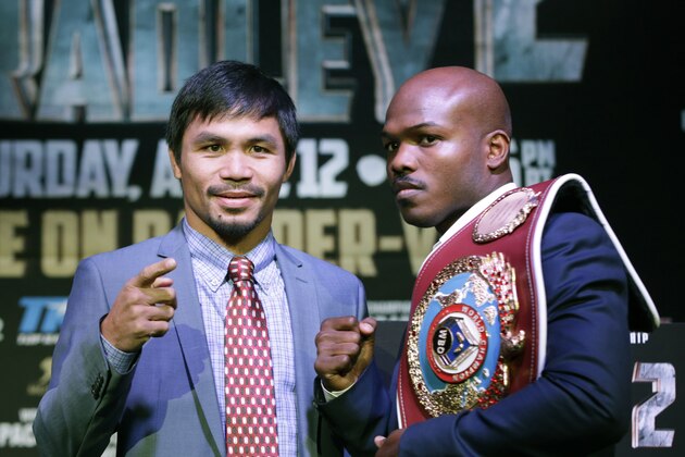 FILE - In this Feb. 6, 2014 file photo, boxer Manny Pacquiao, of the Phillipines, left, poses for a photo with current WBO World Welterweight champion Timothy Bradley of Indio, Ca., during a press conference in New York. Bradley believes former pound-for-pound king Pacquiao has lost his competitive fire heading into Saturday's, April 12, 2014 welterweight rematch in Las Vegas.  (AP Photo/Kathy Willens)