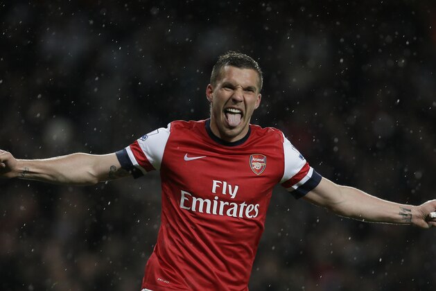 Arsenal's Lukas Podolski celebrates after scoring a goal against Wigan Athletic during their English Premier League soccer match at Arsenal's Emirates stadium in London, Tuesday, May  14, 2013. (AP Photo/Alastair Grant)