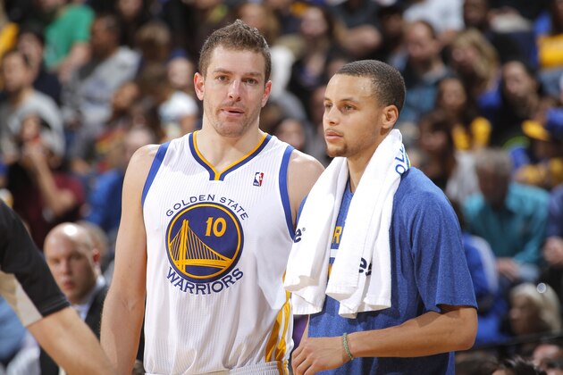 OAKLAND, CA - MARCH 18: David Lee #10 chats with teammate Stephen Curry #30 of the Golden State Warriors while facing the Orlando Magic on March 18, 2014 at Oracle Arena in Oakland, California. NOTE TO USER: User expressly acknowledges and agrees that, by downloading and or using this photograph, user is consenting to the terms and conditions of Getty Images License Agreement. Mandatory Copyright Notice: Copyright 2014 NBAE (Photo by Rocky Widner/NBAE via Getty Images)