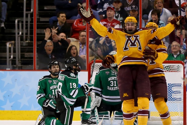 PHILADELPHIA, PA - APRIL 10:  Justin Holl #12 of the Minnesota Golden Gophers celebrates his game winning goal with teammate Seth Ambroz #17 as Dillon Simpson #18 and Rocco Grimaldi #19 of the North Dakota Fighting Sioux looks on during the 2014 NCAA Division I Men's Hockey Championship Semifinal at Wells Fargo Center on April 10, 2014 in Philadelphia, Pennsylvania.The Gophers defeated the Fighting Sioux 2-1.  (Photo by Elsa/Getty Images)