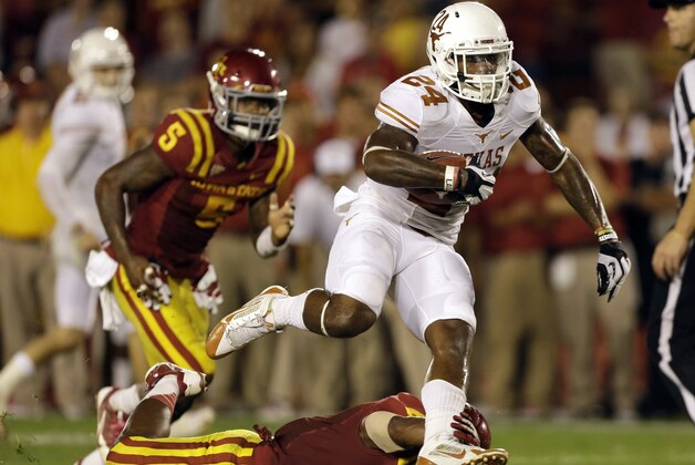 Texas running back Joe Bergeron (24) runs over Iowa State defensive back Sam E. Richardson during the second half of an NCAA college football game on Thursday, Oct. 3, 2013, in Ames, Iowa. Texas won 31-30. (AP Photo/Charlie Neibergall)