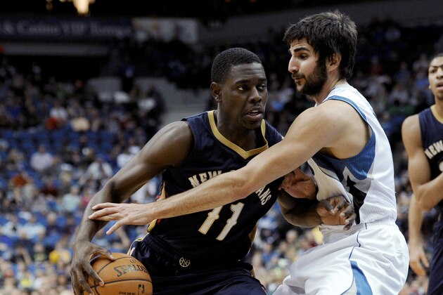 Minnesota Timberwolves guard Ricky Rubio, right, defends New Orleans Pelicans guard Jrue Holiday (11) during the first quarter of an NBA basketball game Wednesday, Jan. 1, 2014, in Minneapolis. (AP Photo/Hannah Foslien)