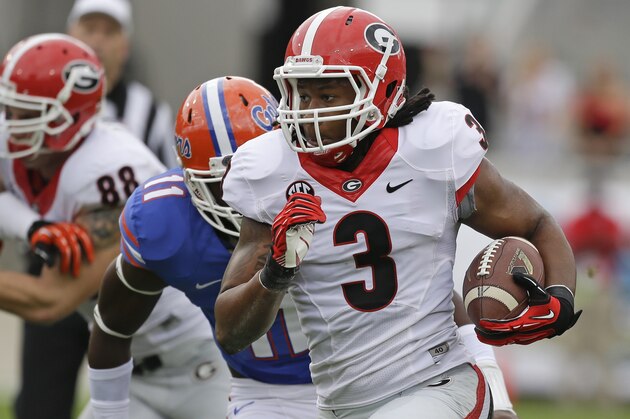 Georgia running back Todd Gurley (3) runs for 25-yards past Florida linebacker Neiron Ball (11) during the first half of an NCAA college football game in Jacksonville, Fla., Saturday, Nov. 2, 2013.(AP Photo/John Raoux)