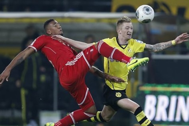 Bayern's Jerome Boateng, left, and Dortmund's Marco Reus challenge for the ball during the German first division Bundesliga soccer match between BvB Borussia Dortmund  and Bayern Munich in Dortmund, Germany, Saturday, Nov. 23, 2013. (AP Photo/Frank Augstein)