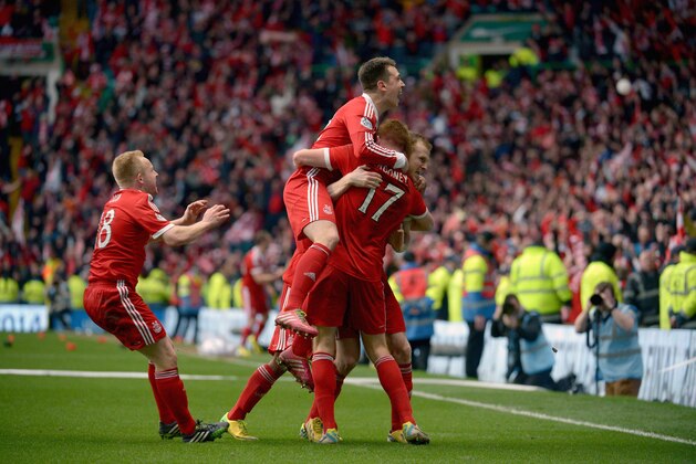 GLASGOW, SCOTLAND - MARCH 16:  Aberdeen players celebrate after beating Caledonian Thistle on penalties during the Scottish Communities League Cup Final at Celtic Park Stadium between Aberdeen and Caledonian Thistle on March 16, 2014 in Glasgow, Scotland.  (Photo by Jeff J Mitchell/Getty Images)