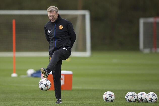 Manchester United's manager David Moyes controls the ball as his team trains at Carrington training ground in Manchester, Tuesday, April 8, 2014. Manchester United will play at Bayern Munich in Germany in a Champions League quarter final second leg soccer match on Wednesday. (AP Photo/Jon Super)