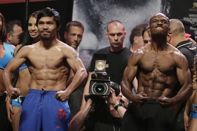 Manny Pacquiao, left, and Timothy Bradley pose for photos following a weigh-in for their WBO welterweight championship boxing match Friday, April 11, 2014, in Las Vegas. (AP Photo/Isaac Brekken)