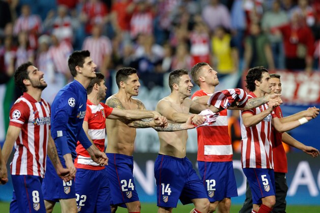 Atletico players celebrate at the end of the Champions League quarterfinal second leg soccer match between Atletico Madrid and FC Barcelona in the Vicente Calderon stadium in Madrid, Spain, Wednesday, April 9, 2014. Atletico defeated Barcelona 1-0. (AP Photo/Paul White)