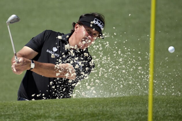 Phil Mickelson hits out of a bunker on the second hole during the first round of the Masters golf tournament Thursday, April 10, 2014, in Augusta, Ga. (AP Photo/Chris Carlson)