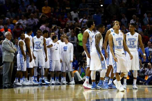 SAN ANTONIO, TX - MARCH 21: Members of the North Carolina Tar Heels celebrate during the closing seconds of their 79-77 win over the Providence Friars during the second round of the 2014 NCAA Men's Basketball Tournament at AT&T Center on March 21, 2014 in San Antonio, Texas.  (Photo by Tom Pennington/Getty Images)