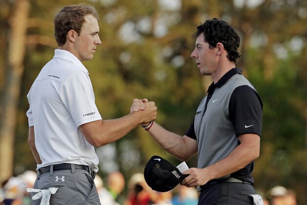 Jordan Spieth, left, shakes hands with Rory McIlroy, of Northern Ireland, on the 18th green following their second round of the Masters golf tournament Friday, April 11, 2014, in Augusta, Ga. (AP Photo/Charlie Riedel)