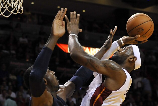 Apr 11, 2014; Miami, FL, USA; Miami Heat forward LeBron James (6) is pressured by Indiana Pacers center Roy Hibbert (55) during the first half at American Airlines Arena. Mandatory Credit: Steve Mitchell-USA TODAY Sports