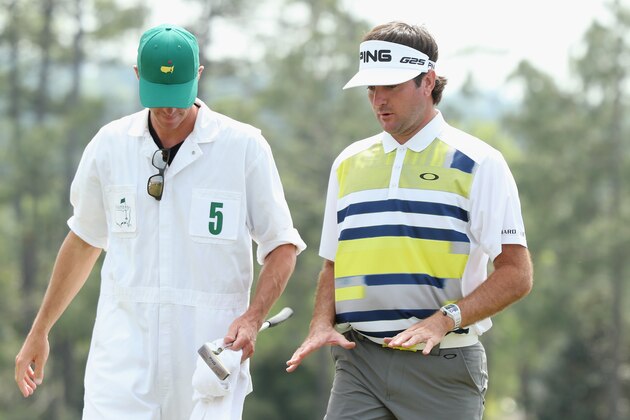 AUGUSTA, GA - APRIL 11:  Bubba Watson of the United States talks with his caddie Ted Scott after completing the second round of the 2014 Masters Tournament at Augusta National Golf Club on April 11, 2014 in Augusta, Georgia.  (Photo by Andrew Redington/Getty Images)