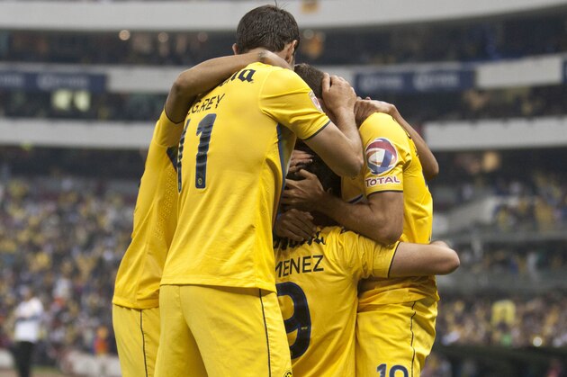 America's Raul Jimenez, , bottom center  celebrates after scoring against Tigres during a Mexican soccer league match in Mexico City, Sunday, Dec.  1, 2013. (AP Photo/Christian Palma)
