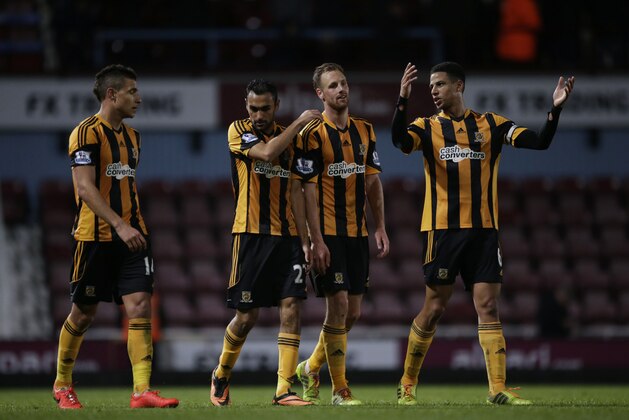Hull City's, from left, Jake Livermore, Ahmed Elmohamady, David Meyler and Curtis Davies walk off the pitch together after being defeated 2-1 at the end of the English Premier League soccer match between West Ham and Hull City at Upton Park stadium in London, Wednesday, March 26, 2014.  (AP Photo/Matt Dunham)