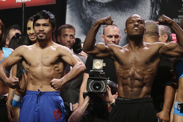 Manny Pacquiao, left, and Timothy Bradley pose for photos following after the weigh-in for Saturday's WBO welterweight championship boxing match, Friday, April 11, 2014, in Las Vegas. (AP Photo/Isaac Brekken)