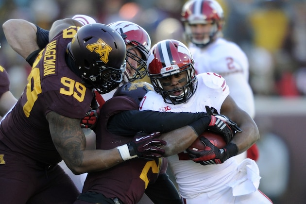 MINNEAPOLIS, MN - NOVEMBER 23: Ra'Shede Hageman #99 and Cedric Thompson #2 of the Minnesota Golden Gophers tackle James White #20 of the Wisconsin Badgers during the first quarter of the game on November 23, 2013 at TCF Bank Stadium in Minneapolis, Minnesota. The Wisconsin Badgers defeated the Minnesota Golden Gophers 20-7. (Photo by Hannah Foslien/Getty Images)
