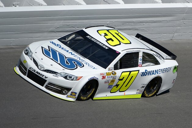 Parker Kligerman (30) drives through Turn 4 during qualifying for the NASCAR Daytona 500 auto race at Daytona International Speedway in Daytona Beach, Fla., Sunday, Feb. 16, 2014. (AP Photo/Phelan M. Ebenhack)