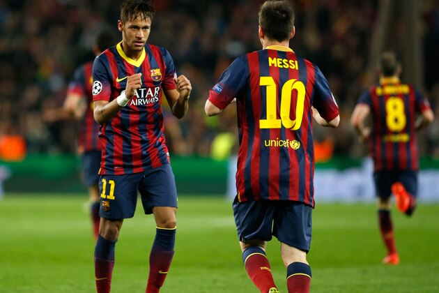 Barcelona's Neymar, left, celebrates with teammate Lionel Messi after scoring his side's first goal during a first leg quarterfinal Champions League soccer match between Barcelona and Atletico Madrid at the Camp Nou stadium in Barcelona, Spain, Tuesday April 1, 2014. (AP Photo/Emilio Morenatti)