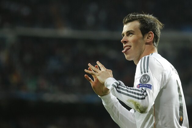 Real's Gareth Bale celebrates scoring the opening goal during a Champions League quarterfinal first leg soccer match between Real Madrid and Borussia Dortmund at the Santiago Bernabeu stadium in Madrid, Spain, Wednesday April 2, 2014. (AP Photo/Paul White) Real's Gareth Bale celebrates scoring the opening goal during a Champions League quarterfinal first leg soccer match between Real Madrid and Borussia Dortmund at the Santiago Bernabeu stadium in Madrid, Spain, Wednesday April 2, 2014. (AP Photo/Paul White)