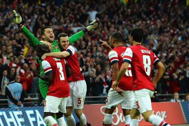 LONDON, ENGLAND - APRIL 12:  Lukasz Fabianski of Arsenal celebrates winning the penalty shoot out with team mates during the FA Cup Semi-Final match between Wigan Athletic and Arsenal at Wembley Stadium on April 12, 2014 in London, England.  (Photo by Shaun Botterill/Getty Images)