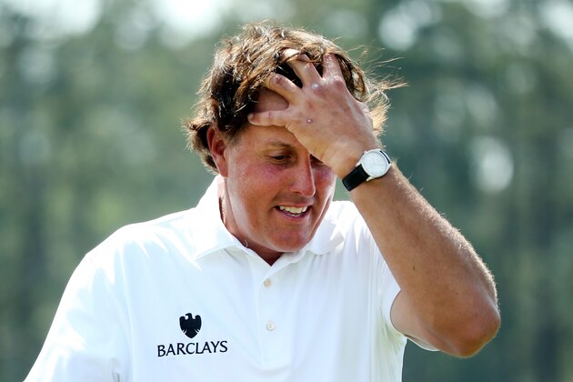 AUGUSTA, GA - APRIL 11:  Phil Mickelson of the United States walks off the 18th green after completing the second round of the 2014 Masters Tournament at Augusta National Golf Club on April 11, 2014 in Augusta, Georgia.  (Photo by Andrew Redington/Getty Images)