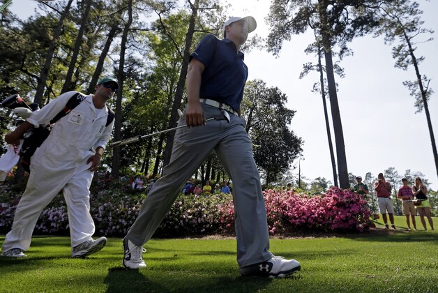 Jordan Spieth walks with his caddie Michael Greller to the sixth green during the third round of the Masters golf tournament Saturday, April 12, 2014, in Augusta, Ga. (AP Photo/Darron Cummings)