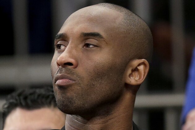 Los Angeles Lakers' Kobe Bryant looks on from the bench during the second half of an NBA basketball game against the New York Knicks at Madison Square Garden, Sunday, Jan. 26, 2014, in New York. The Knicks defeated the Lakers 110-103. (AP Photo/Seth Wenig)