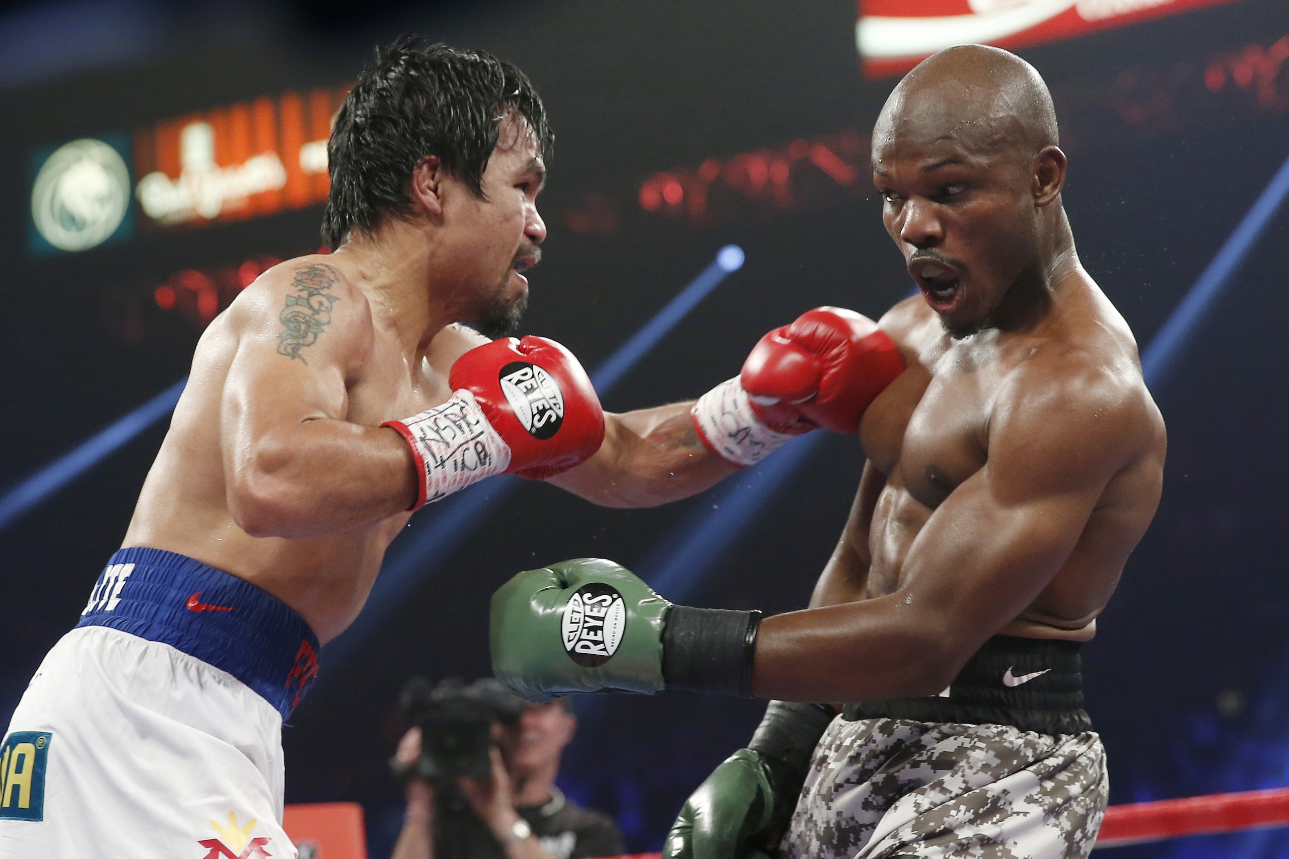 Manny Pacquiao, left, of the Philippines, throws a left at Timothy Bradley during the WBO welterweight title boxing bout Saturday, April 12, 2014, in Las Vegas. (AP Photo/Eric Jamison)