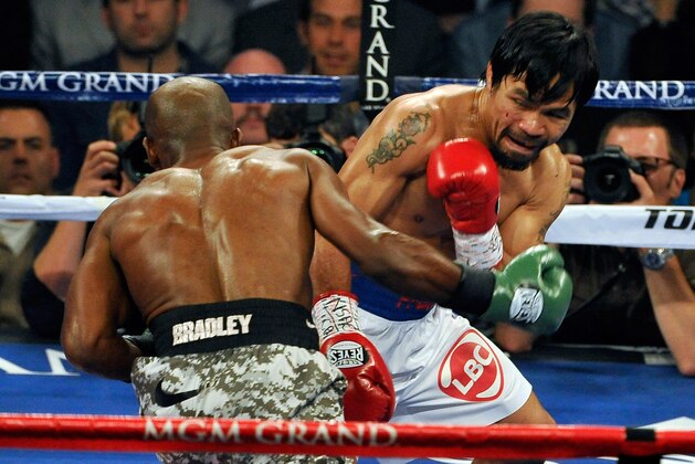 LAS VEGAS, NV - APRIL 12:  Manny Pacquiao (R) and Timothy Bradley fight during their WBO world welterweight championship boxing match at the MGM Grand Garden Arena on April 12, 2014 in Las Vegas, Nevada.  (Photo by David Becker/Getty Images)