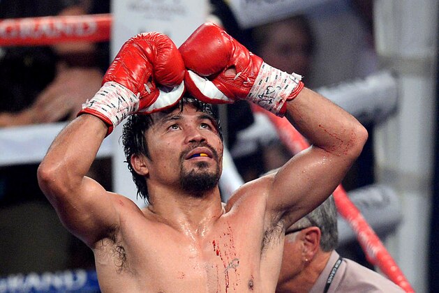 Apr 12, 2014; Las Vegas, NV, USA; Manny Pacquiao  celebrates his victory over Timothy Bradley (not pictured) after their WBO World Welterweight Title bout at MGM Grand Garden Arena. Pacquiao won via unanimous decision. Mandatory Credit: Joe Camporeale-USA TODAY Sports